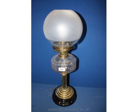 An Oil lamp, converted to electric, with brass reeded column base and clear glass reservoir.