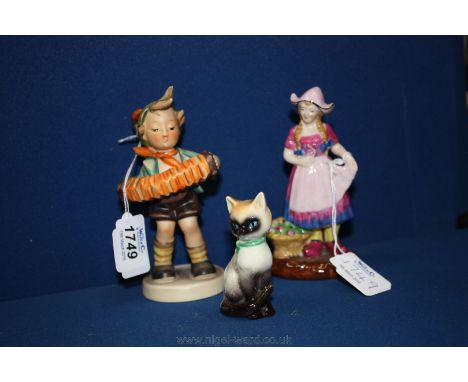 A Hummel figure of a boy playing squeeze box, an Arcadian figure of a Tulip's girl and a small china German sitting cat