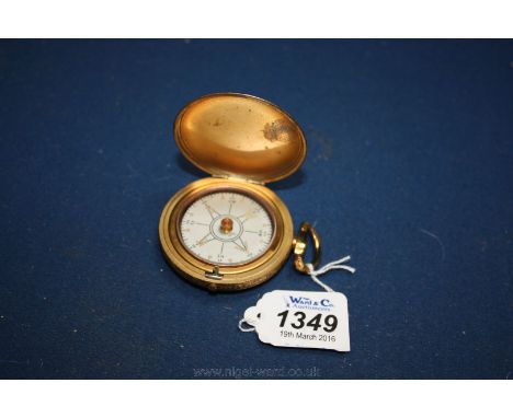 A yellow metal Pocket watch style Compass.