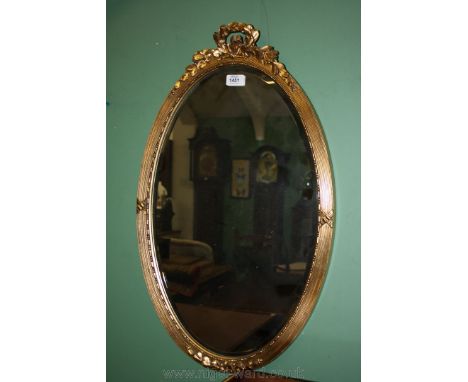 An oval gilt framed bevel plated Mirror with laurel leaf top, 28'' x 17''.