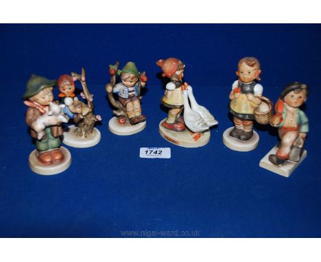 Six Hummel figures including a boy with a lamb, boy in apple tree, boy with umbrella, a/f, girl with geese, girl with basket 
