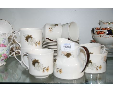 A Royal Doulton 'Westwood' pattern Teaset with a bread/butter plate, five plates, six cups, seven saucers, sugar bowl and mil