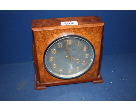 An Art Deco Walnut cased mantle Clock with silvered dial and gilt number/hands, R. Chambers, Luton, having Swiss eight day mo