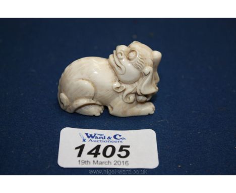 A Japanese Ivory Netsuke of a Fu Foo Dog/Shishi/Lion Dog, signed