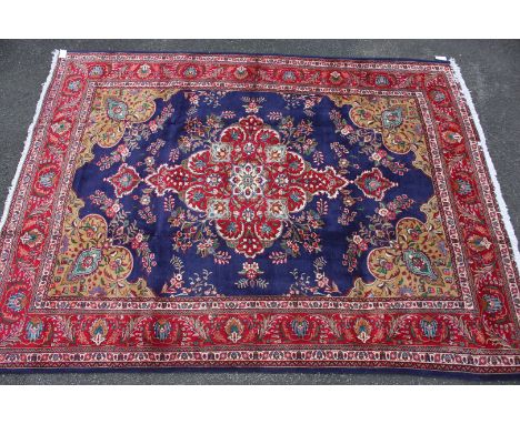 A fine and attractive hand made Tabriz Carpet, Northwest Persia, the abrashed indigo field sparsely decorated with rosettes c