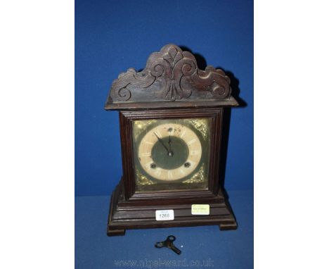 A late 19th c. Oak cased architectural Mantle Clock, having fret cut pediment top with applied foliage style moulding. Brass 