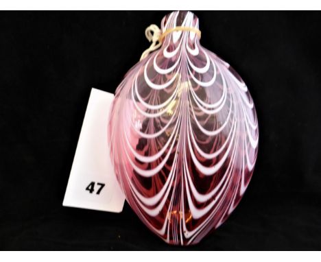 A Nailsea glass flask, 19th century, of flattened ovoid form with in graduated cranberry red glass with combed white swirls, 