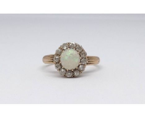 An 18ct opal and diamond cluster ring, size N.