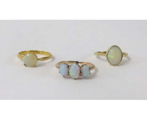 Three opal set rings including 18ct.