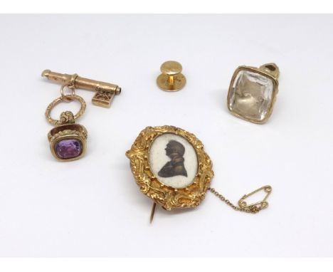 An antique amethyst set seal, a large clear glass seal with portrait, a single stud and a 19th century gold mourning brooch w