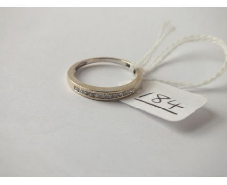 A diamond half-eternity ring in 9ct - size N - 1.8gms