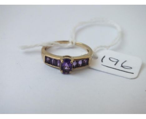 A 9ct ring set with baguette-cut amethysts - size N - 2.47gms