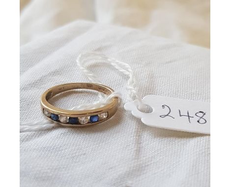 A blue &amp; white 7 stone 1/2 eternity ring in 9ct - size J - 1.7gms