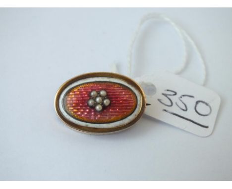 A gold &amp; enamel oval brooch 