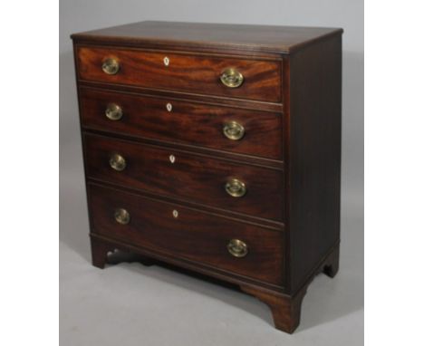 A George III mahogany chest, of four long drawers with plate back handles, shield shape escutcheons and bracket feet, with ov
