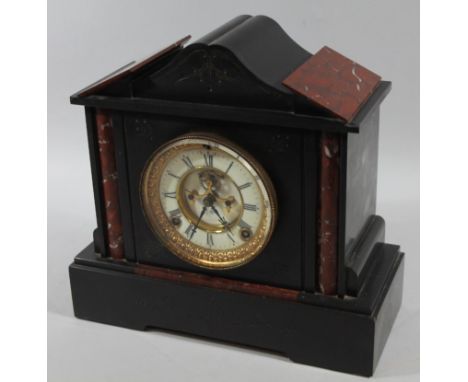 A late Victorian architectural slate and red marble mantel clock, the 11cm dia. Roman numeric dial with partially open moveme