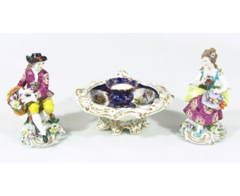 A pair of very early 20thC Continental figures of a lady and gentleman, she holding bonnet, he a basket, each in seated pose 