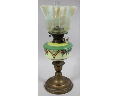 A very early Edwardian oil lamp, with vaseline green and clear glass floral shade, clear funnel and floral polychrome glass r