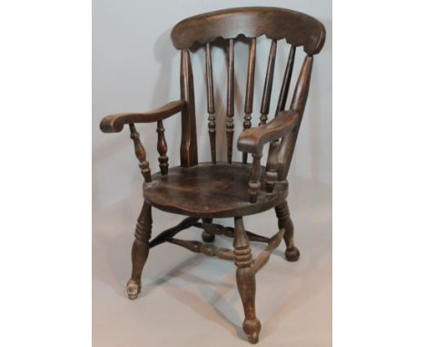 A late 19thC ash and elm Windsor type chair. with comb top, cylindrical turned vertical splat, heavy scroll arms and shaped s
