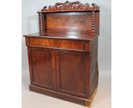 A Victorian mahogany chiffonier, of small proportion, the pierced scroll cornice raised above a serpentine shelf held on barl