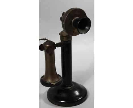 A mid 20thC candlestick telephone, with cylindrical stem, cord ear horn, and circular foot, partially decorated in black, 31c