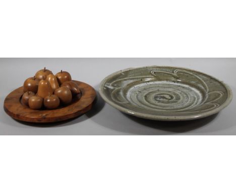 A 20thC Studio pottery charger, of large proportion, sparsely decorated in green and cream, with a swirl pattern on circular 