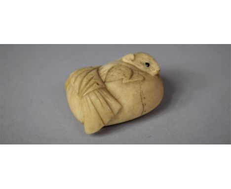 A Japanese Late Meiji Period Carved Ivory Netsuke in the Form of a Sack with Mouse having Stained Black Eyes, 4cm Wide 