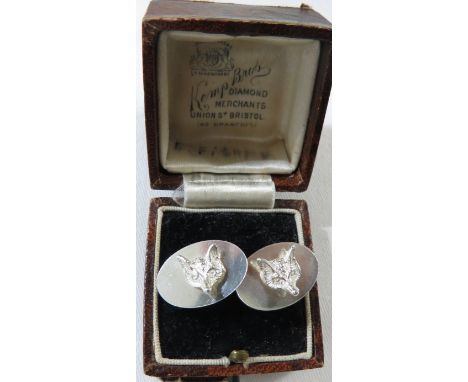 A pair of silver fox head cufflinks, oval settings, Birmingham assay, maker's stamp WM, combined weight 7g, with Kemp Bros ri