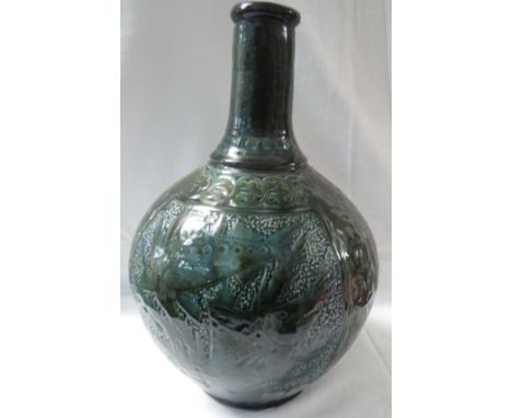 C H Brannam Barum pottery vase of bottle shape, glazed in sea green and olive green with three panels of fish pairs amongst s
