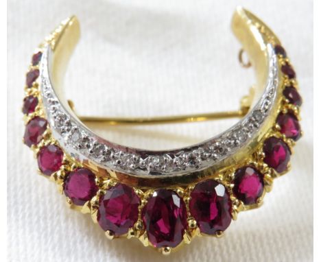 **Payment in person or by bank transfer only**An 18ct gold ruby and diamond crescent or horseshoe brooch, fifteen graduated o