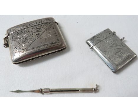 A silver tooth pick and two vestas - the pick with engine turned cylinder, length extended 7cm; the smaller vesta with foliat