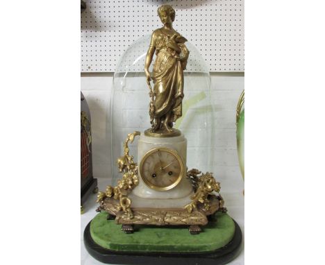 A French striking eight day ormolu mounted white marble mantle clock swathed with floral wreathes and surmounted with a gilt 