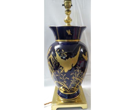 A cobalt blue and gilt vase converted to a table lamp with pleated and tasseled shade, the vase in cobalt blue with flared ri