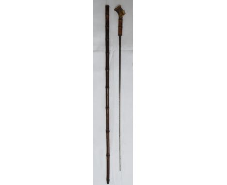 A 19th Century bamboo sword stick / cane, the triangular steel blade marked with Roman numerals 'VVI' and with a carved Antle