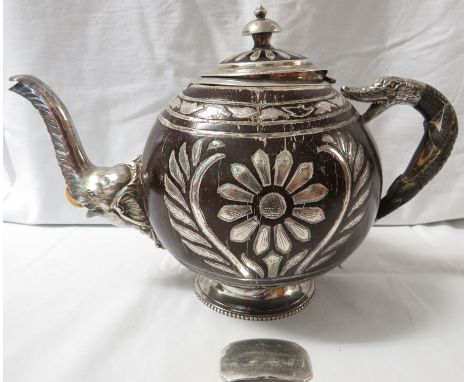 An Indian white metal mounted presentation coconut teapot with elephant mask spout, snake finial and shaped handle, together 