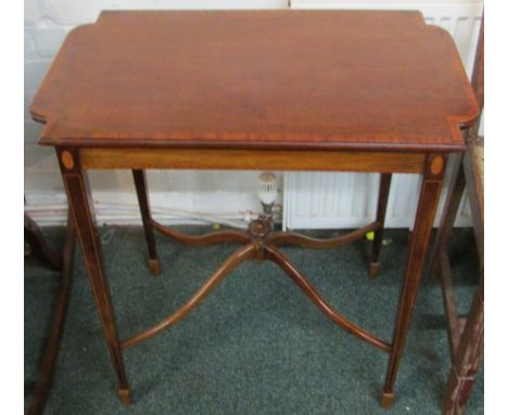 A Victorian banded mahogany side table with a shaped top on four slender square tapering legs with boxwood stringing united w