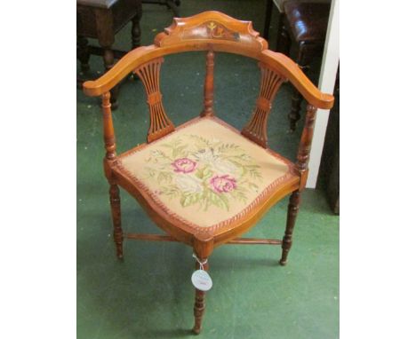 An Edwardian pale mahogany corner chair with boxwood stringing and foliate inlay with lyre splats, turned baluster legs and t