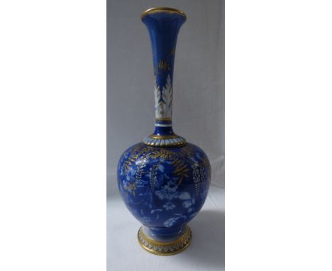 A Royal Worcester porcelain vase of bottle shape with slender neck moulded with acanthus, graduated blue ground with resist p
