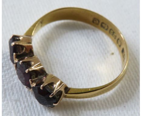 22ct gold ring set with three garnets, British assay marks, total weight of ring 3.2g, size P for guidance only