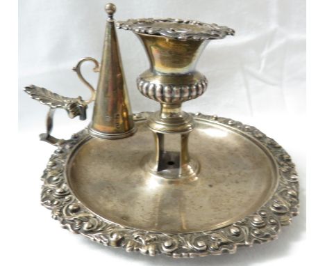 George IV silver chamber stick and detachable extinguisher, the dish with a moulded foliate scrolled border, the candle holde