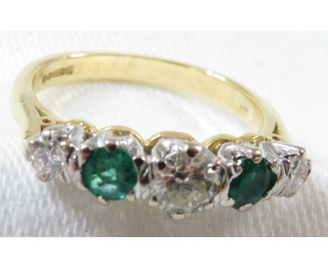 18ct gold ring set with a row of three graduated brilliant cut diamonds spaced by two emeralds, the largest central diamond e