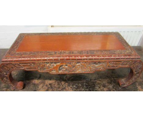 A Chinese redwood scroll end vase stand, the frieze carved with landscape and foliage, the top with a geometric and foliate b