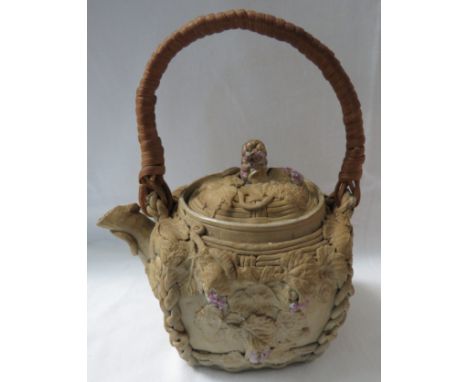 Japanese buff stoneware teapot with applied basketwork and foliage, isolated enamel and gilt details, wicker handle, impresse
