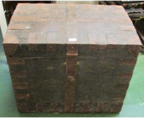 A late 19th century large stained pine trunk with iron banding, brass escutcheon (lock mechanism absent), with a shallow dome
