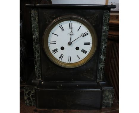 A Victorian eight day striking mantle clock with marble trim, white enamel dial and Roman chapter. The maker's name is indist