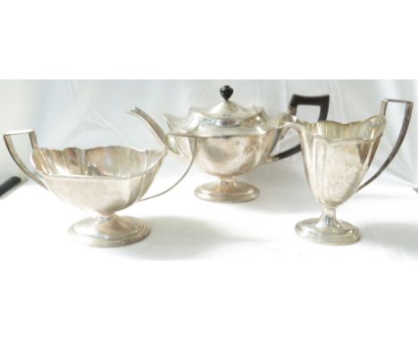 An Edwardian silver three-part tea set comprising a teapot of shaped oval form with a slender spout, Bakelite handle and ebon