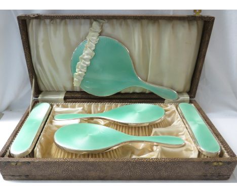 A cased silver and green guilloche enamel five piece dressing table set including hand mirror, clothes and hair brushes