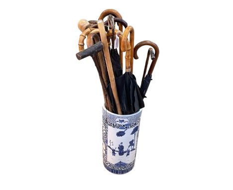 Collection of walking canes and parasol including silver mounted, horn, bamboo, housed in blue and white Oriental style stick