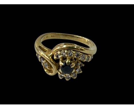 Sapphire and diamond ring set in 18 carat yellow gold, size J.