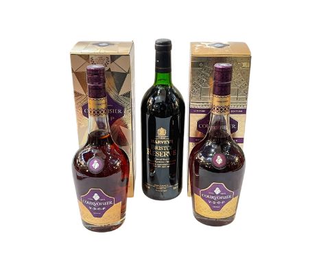 Two bottles of Courvoisier VSOP cognac, and bottle of Hardy's Bristol Reserve.